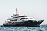 A large yacht sailing through water.