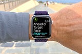 An Apple Watch being worn by a jogger telling them that they are ‘ahead of their target pace’
