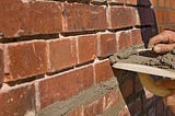 How can Cracked Cement Mortar on a Brick Structure be Effectively Repaired?