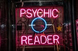 Neon sign saying “Psychic Reader”