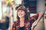 A confident woman in her 50s smiles
