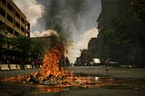 A burning pile of rubbish — clearly the aftermath of a destructive riot