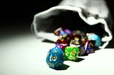 A set of role playing dice spilling out of a cloth bag