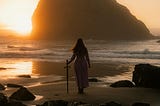 A young woman with long hair, in a dress, sword in hand, looks out on a sunset over the ocean, her back to the viewer.