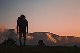 man hiking at sunset