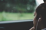 Girl looking through a car window