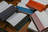 a stack of blank open journals, waiting to be written in