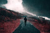 Man walking in rain with umbrella on a loneley road