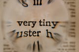 Small, blurry background text with the words “very tiny” magnified