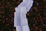 A trail of opened books on a bed of leaves