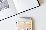 The Fool summary pictured with a tarot deck and cards