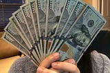 Girl Holding $100 bills