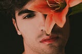 beautiful sultry man with flower
