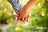 A photo of a boy and girl holding hands
