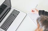 A girl writing on notepad