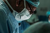 A doctor carefully performs an organ transplant procedure, utilizing advanced artificial organs and tissue engineering technologies to enhance patient health and well-being.