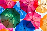 Bright umbrellas, open, against a blue sky