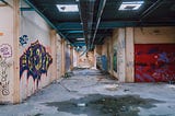 Decaying and spray painted subway station.