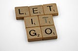 scrabble, scrabble pieces, lettering, letters, wood, scrabble tiles, white background, words, type, typography, design, layout, let it go, forgive, forgiveness, obsession, frozen, disney, move on, regret, despair, 
