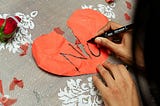 A heart shape paper with text “No”