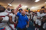 Giants head coach Brian Daboll celebrating with the team post-victory.