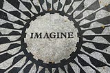 close up of the word imagine from the strawberry fields mosaic floor in NYC