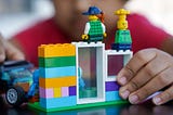 Photo of toy people sitting on a building made of Legos, by Ravi Palwe on Unsplash