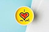 an image shows “I love my job” in a coffee mug