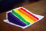 A piece of cake colored as the Pride flag