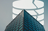 An Image showing a tall building and a picture of relational database in white color. Image Credits:https://twitter.com/deisbel/status/1726636951548096816