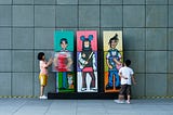 Kids watching and interacting with art depicting personality