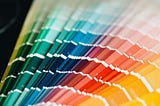 A full spectrum of paint swatches from green to yellow, symbolizing a rainbow