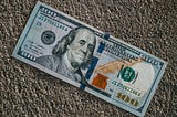 A Americal $100 note on the pavement