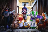 Toy Story characters; out of focus: a boy carrying a Captain America backpack.