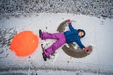 child making snow angel