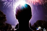 A person is watching fireworks bursting in the sky. firework safety 4th of July, Memorial Day, summer