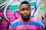 A young, Black man looking into the camera.