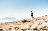 A man runs down a hill.