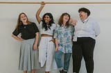 4 women laughing together