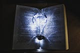 picture of lightbulb illuminating a book