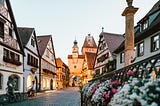 cute, historic German town with coppel stone street and flowers on the side of the road