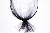 Black balloon. A black tulle covered balloon. A balloon being held. An inflated black, tulle covered, balloon. Black nail polish.