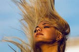 Women with blonde hair flying in the wind