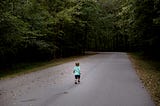 kid running away down a road