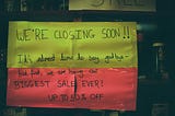 Green and red “we are closing” sign