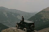 Off road car and person sitting on top of it