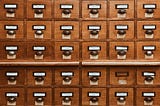 A file cabinet with small compartments of drawers