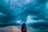 woman in striped shirt staring into storm