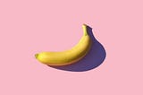 riped banana on pink surface