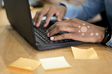 A user experience researcher with laptop and sticker notes